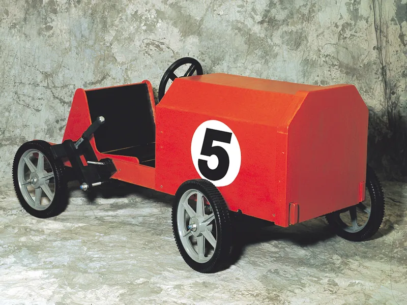 Children's wood coaster car is painted red with a racing number on the side